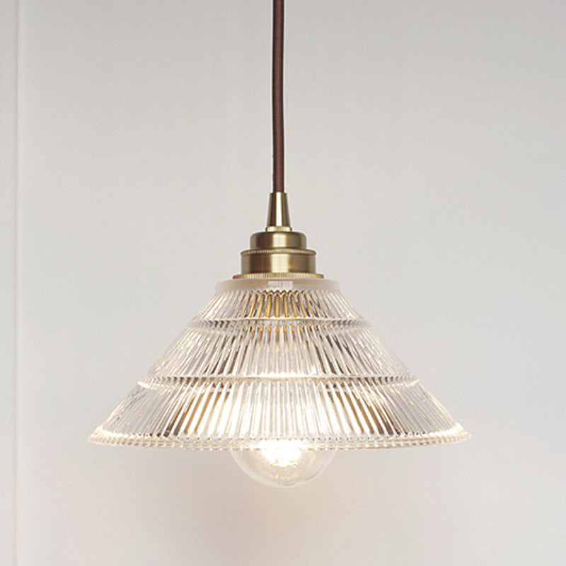 Enhance Your Dining Room With Industrial Elegance: The Brass Cone Pendant Clear Ribbed Glass