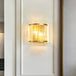 Modern Elegance Meets Warmth: Gold Ribbed Glass Wall Sconce