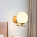 Modern Elegance Meets Warmth: Gold Sphere Bedside Wall Sconce