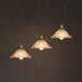 Illuminate Your Dining Room With Industrial Elegance: The 3 - Light Brass Cone Pendant Ribbed Glass